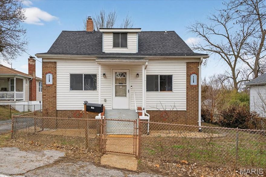 Sweet, charming, and full of character, this inviting 1.5-story home offers warmth, comfort, and flexible living in a setting that instantly feels welcoming. Blending charm with everyday functionality, the home provides spaces that feel both comfortable and easy to love. Upon entering, a spacious enclosed porch welcomes you into the home, offering a bright, inviting entry that serves as a seamless transition into the main living area. Step inside to the welcoming family room, where durable LVP flooring and a ceiling fan create a relaxed space to unwind or gather. The layout flows naturally into the bright and cheerful kitchen, featuring ceramic tile flooring, custom cabinetry, pantry, laminate countertops, dual-basin sink, and a charming tile backsplash. White appliances, including a gas range, built-in microwave, and refrigerator, complete the space, making daily living simple and comfortable. Two cozy main-level bedrooms offer comfortable living with LVP flooring, ceiling fans, and closet space, while the hall bath features ceramic tile flooring, a comfort-height vanity, medicine cabinet, and classic tub/shower combination. Just beyond, the enclosed back porch adds wonderful bonus space, perfect for morning coffee, a sweet retreat within the home. Upstairs, the private bedroom feels peaceful and tucked away, showcasing warm hardwood floors and beautiful wood paneling that add to the home’s charm. This flexible space works beautifully as a primary bedroom, home office, creative studio, or quiet getaway. The unfinished basement offers laundry hookups, sump pump, and generous storage, with room for future potential. Step outside to enjoy the wood deck and fully fenced front and backyard, offering space for pets, gardening, entertaining, or simply relaxing outdoors. The brick and vinyl exterior adds timeless curb appeal and durability. Warm, welcoming, and full of character, this charming home offers comfortable living with flexibility and a cozy feel that makes it easy to imagine calling it home.