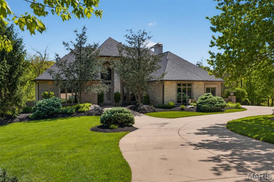 Tucked away on over 3 acres, this exceptional custom estate offers a rare blend of privacy, luxury, and resort-style living. Expansive indoor spaces and exceptional outdoor amenities create a true retreat defined by privacy and natural surroundings. A grand entry with soaring 18-foot ceilings create an immediate sense of arrival, flanked by a private office with custom built-ins and a formal dining room. Beyond, a dramatic two-story great room is anchored by a gas fireplace and walls of bay windows that fill the space with natural light. Well-appointed for both everyday living and entertaining, the kitchen offers custom cabinetry, granite countertops, a statement island, gas range, stone backsplash, walk-in pantry, and premium stainless appliances. A built-in wet bar enhances the space, while the breakfast room with fireplace opens to both decks for a seamless transition outside. The main composite deck features a gas fireplace and built-in Green Egg grill and leads down to a spacious covered living space and outdoor oasis. The main-floor primary suite offers a true private escape, complete with a coffered ceiling, bay windows, and a dual-sided gas fireplace shared with the spa-inspired bath. The ensuite features custom tile, dual comfort-height vanities, a soaking tub, walk-in shower with rainfall head, and a spacious walk-in closet. Upstairs, a loft with custom cabinetry overlooks the great room, along with two spacious bedrooms and well-appointed baths. The finished lower level offers a large bonus room featuring a coffered ceiling and custom stone accent wall, a recreation room with built-ins, additional bedroom and full baths. A temperature controlled wine cellar is complemented by a speakeasy style lounge featuring a custom bar, built-in cabinetry, and dishwasher, creating a one-of-a-kind space for entertaining. A dedicated safe room with a Patriot door and a second laundry room add both function and convenience. And then the outdoor living takes this property to another level. Thoughtfully designed for both entertaining and relaxation, the space is centered around a stunning saltwater pool with a swim-up bar, complemented by a separate spa and beautifully integrated patio areas. A fully equipped outdoor kitchen and covered living space with fireplace create an effortless indoor-outdoor lifestyle. Additional highlights include zoned HVAC, New roof, central vacuum system, oversized 3-car garage with heater & built-in cabinetry. A rare offering that seamlessly blends privacy, craftsmanship, and elevated living, designed for the way you live, entertain, and unwind, just minutes from the charm and beauty of Missouri wine country.