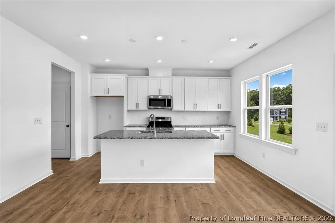 First Floor Plan - Additional Highlights Include: a main floor bedroom with a full bathroom, additional windows in the great room, an expansive shower in the primary bathroom, and a dual sink vanity in the secondary bathroom