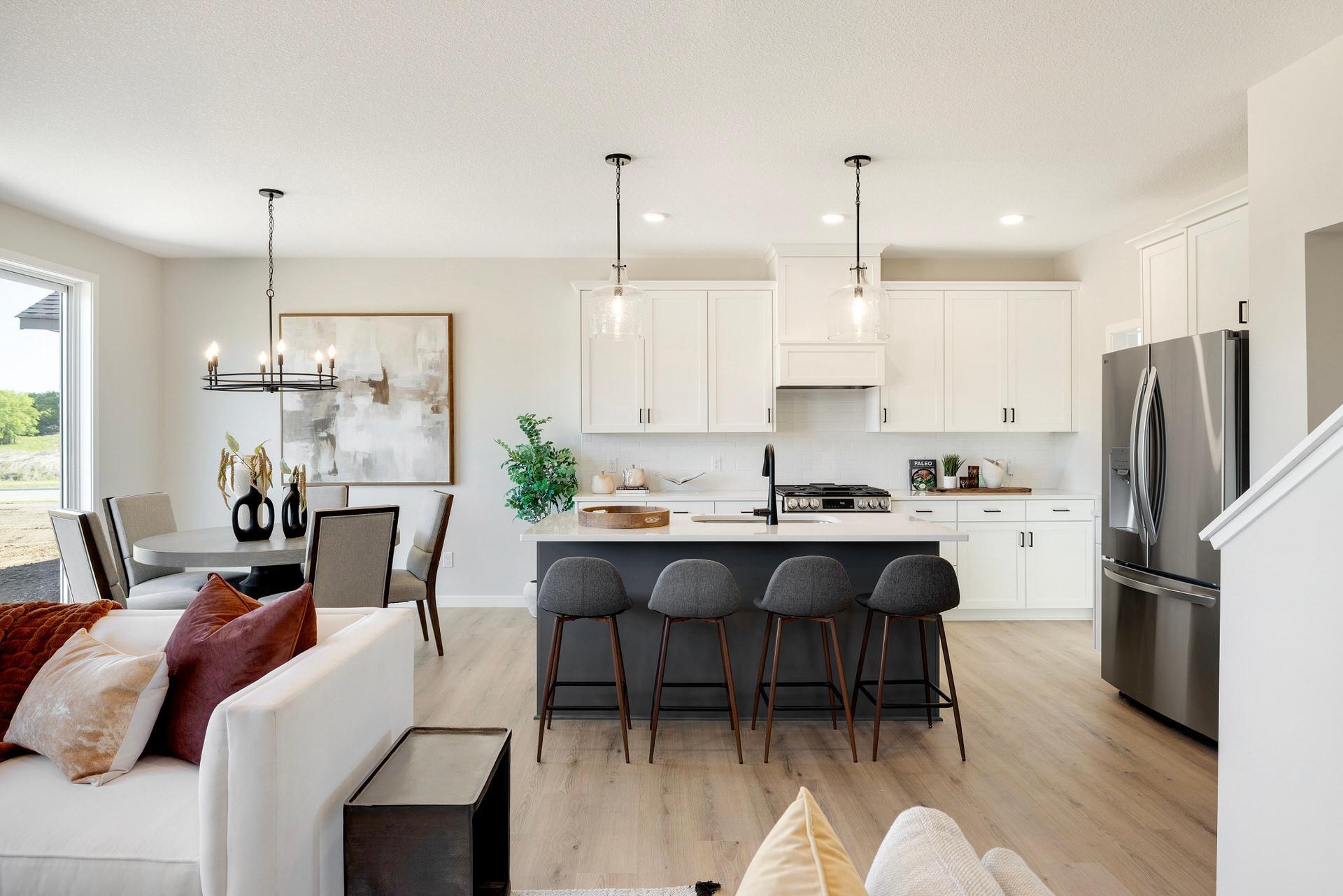 This home offers seamless living with an open flow between the kitchen, dining, & fam room. This layout enhances function ,making it ideal for both everyday living & entertaining. Photos are from previously built home; options & features may vary.