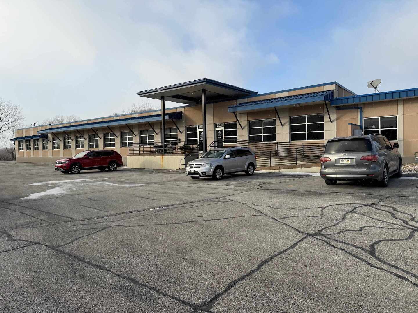 View of property featuring uncovered parking