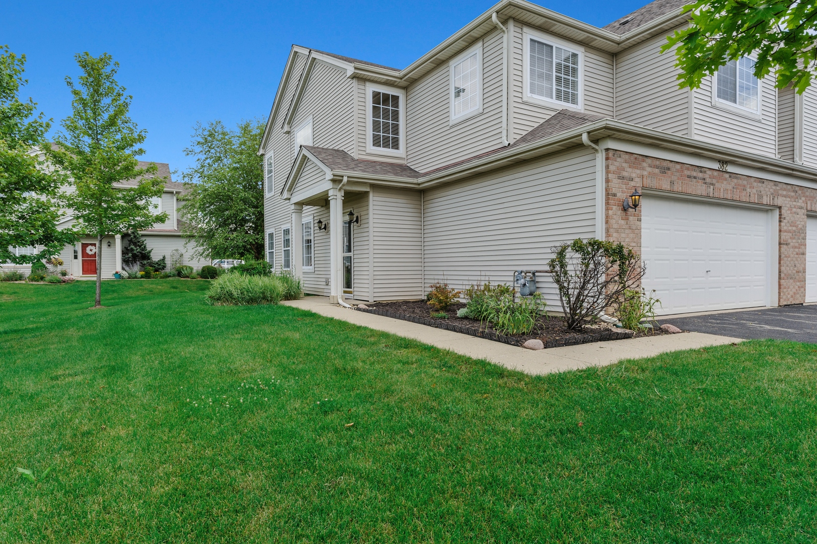 Notice the green space and extra wide 2 car garage