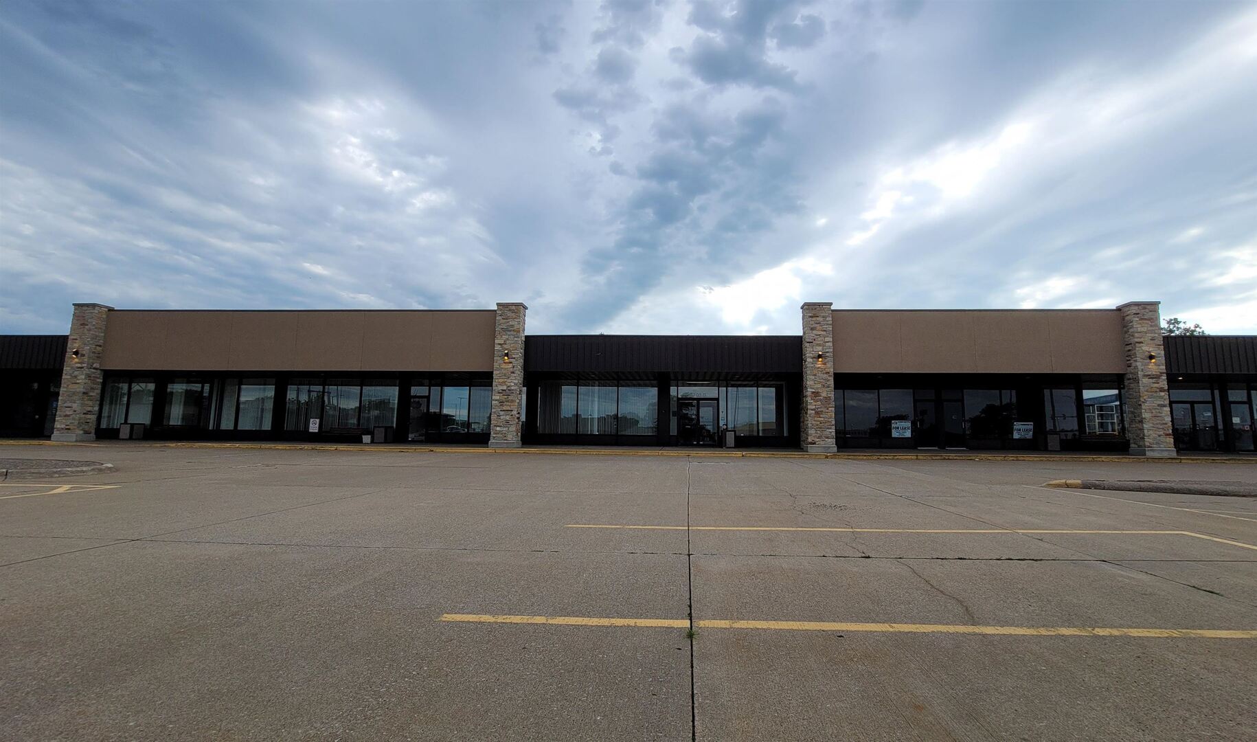 View of commercial property with uncovered parking