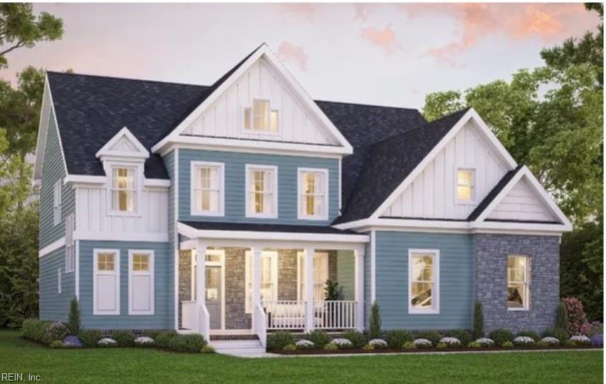 Blue two-story house with stone accents, multiple gables, and a covered front porch.