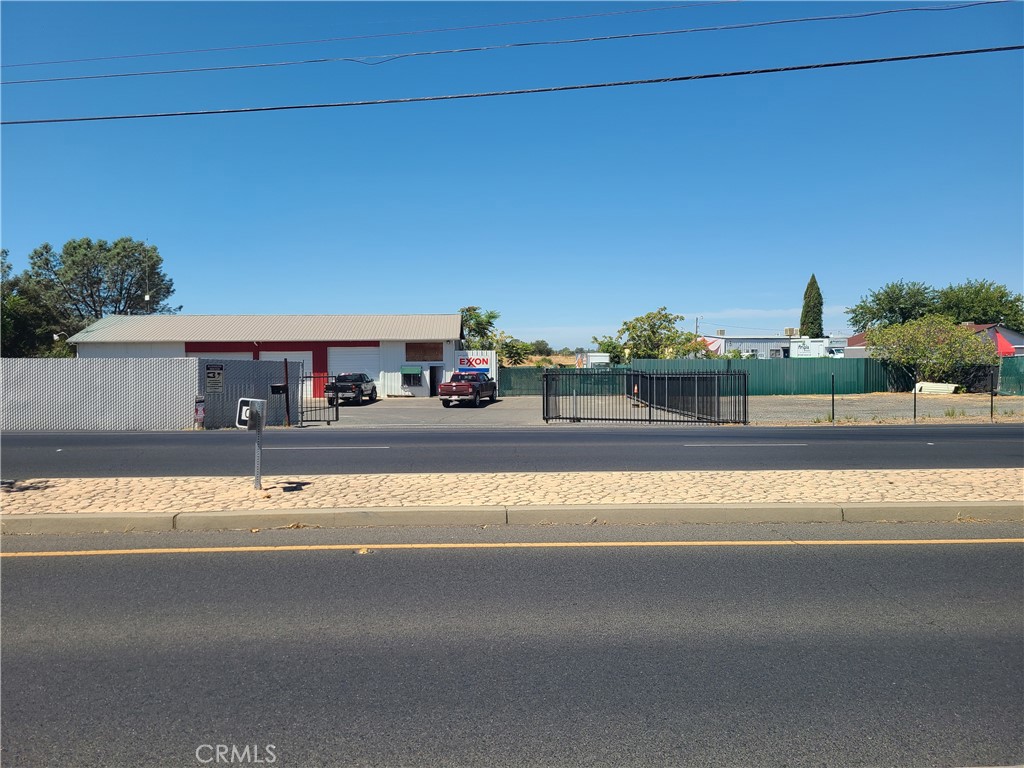 Sets facing Lincoln Blvd, access gate, area completely fenced. 3 bays each with hoists, 2 bathrooms, office, work bench and storage area. Another building with roll up doors. Plenty of space for another automotive repair or contractor shop. Adjacent to large shop are certified scales. Rear of shop plenty of parking, work area covered for working outside with room to park equipment. Very clean ready to get going!!