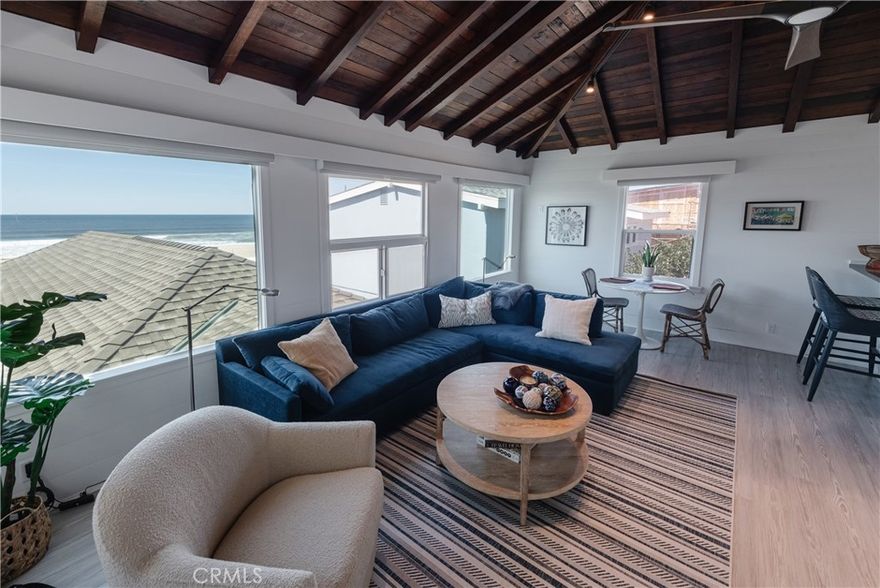 This is an ARE YOU KIDDING ME opportunity to live on the Strand in the primo Section of North Hermosa Beach.  This darling FURNISHED one bedroom  one bathroom cottage-type property has its own entrance up to the one level PERCH where it commands huge direct Western white water views that will make your day, every day.

It's super cute:  The pitched dark wood beamed ceiling contrasts with the white walls and white brick fireplace.  The kitchen is open with high bar seating.  There is a work space or dining table area where you can look out at the ocean.  A stackable washer and dryer is in the unit for convenience.

Darling!