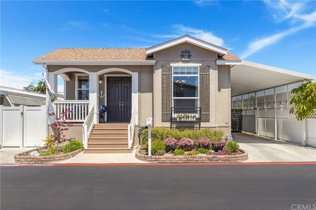 This is a Fabulous Mobile Home in a 55+ Community. Upon entering this home, you will feel a sense of luxurious comfort! The vaulted ceilings and abundance of windows bring a light, bright and wide-open floor plan feel. The Living area, (with a recessed ceiling and modern fan), flows onto the kitchen, complete with large island, ample walk-in pantry and gorgeous Dining Room area. Two secondary bedrooms make for perfect guest rooms or large work-from-home offices. Hardwood white crown molding and baseboard molding run throughout the stylish home. Primary Bedroom is spacious with walk-in-closet and huge bathroom complete with dual sinks, a spacious shower and a bright skylight. The guest bathroom includes a soaking tub and plenty of storage. Laundry Room leads to carport entrance side of the home, which is partially converted into a lovely and relaxing outdoor oasis. The veranda-style front porch has plenty of room to sit outside on your favorite chairs and enjoy an ocean breeze on a summer evening.
Sideyard, with a vinyl gate for privacy, is clean, paved and has plenty of room for storage, a raised garden or...?? The possibilities are endless.
Community Clubhouse makes for wonderful larger parties, or small intimate parties, with a commercial-like working kitchen and tons of space with provided tables, chairs...
Community pool and spa recently upgraded with new outdoor tables, chairs and umbrellas just in time for Summer! This is a lifestyle that offers a beach-close location at an affordable price. Any homeowner will be proud to entertain their family and friends in this home.