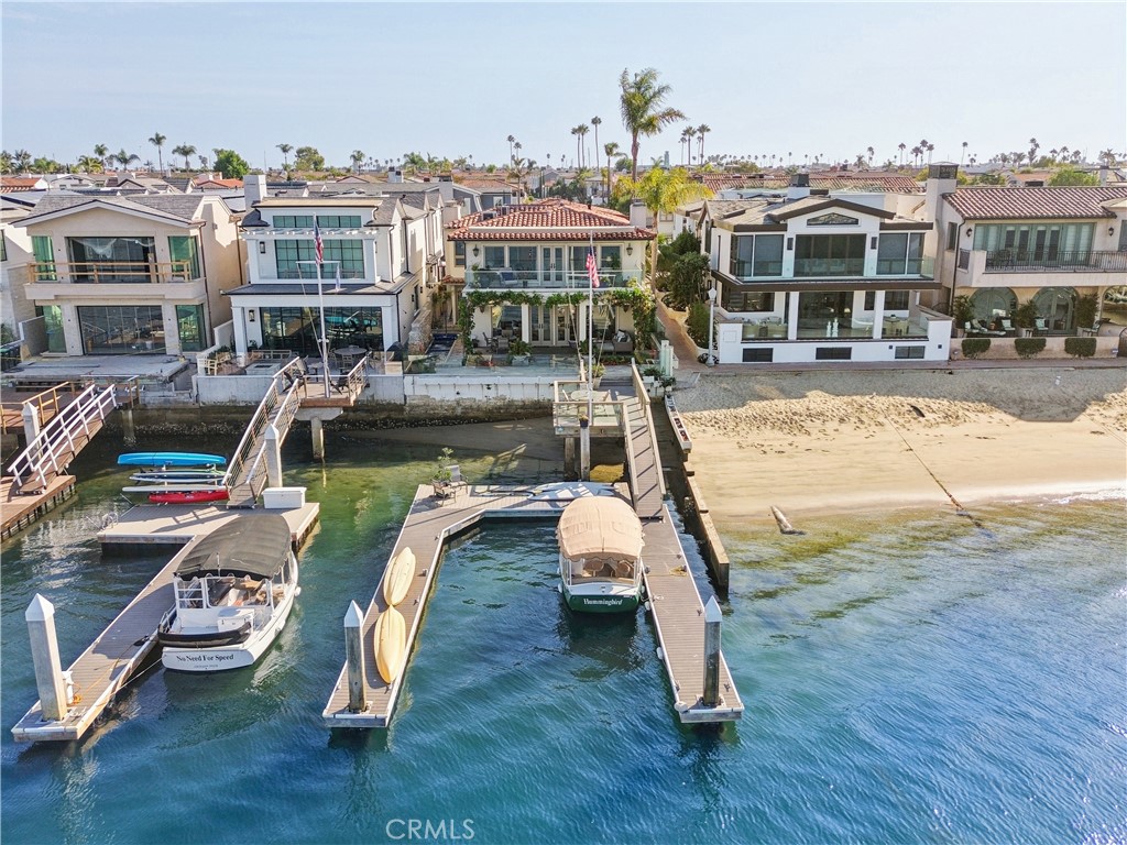 Welcome to this stunning bayfront residence on Lido Island in Newport Beach, offering unparalleled waterfront living with direct access to the sand and breathtaking views of the harbor. This exceptional property boasts a spacious full dock that can accommodate a 55+ foot boat, featuring newer Tech Deck, and being the last dock prior to the Nord strata beach multiple boats can be accommodated. With 5 spacious bedrooms and 4 bathrooms spread across approximately 3,800 sq. ft. of living space, this home is designed for waterfront entertaining and luxurious coastal living. The property also includes a new AC condenser, new LED lighting throughout and multiple living and dining areas that seamlessly blend indoor and outdoor spaces. This property offers a primary formal entry off the strata, a 2-car garage plus additional side entrance, and the main living room and dining room boasts high ceilings leading out to the beautiful waterfront outdoor space. The oversized Primary bedroom features a stunning view with an expansive deck perfect for watching the boat parades, a spacious office retreat and dual cedar lined closets. The exterior patio and deck is an entertainer’s dream, featuring a private plunge pool and Jacuzzi (replastered and retiled in 2024) with a three-fountain water feature, creating a serene ambiance for relaxation and privacy. This lot offers 40 feet of water frontage and a depth of 105 feet giving you slightly over 6000 sq ft of future buildable home space. Situated on a 4,200 sq. ft. lot, the home benefits from a unique strata, providing additional privacy and extra space on the west side of the property. This Lido Island gem offers the perfect blend of modern amenities and timeless charm in one of Newport Beach's most coveted locations with tennis courts, Pickleball courts, a playground and park, as well as private security. Don’t allow this once in a lifetime opportunity to pass you by, make this your private oasis for many years to come!