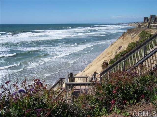 SOLANA BEACH - OCEAN FRONT COMMUNITY - WALK TO BEACHES, SHOPPING, RESTAURANTS, RACE TRACK. Spacious townhome in gated Seascape Sur. Two bedrooms 2 baths plus laundry on entry level. Huge living/dining area upstairs with vaulted ceilings, fireplace, office, 1/2 bath and walk out deck with fabulous views. Newly remodeled kitchen with quartz counter tops and stainless appliances. Fresh paint through out. Two underground reserved parking spaces. Community pools, hot tubs, tennis courts and DIRECT BEACH ACCESS. Truly a beach lovers delight. Short distance to Del Mar Race Track, restaurants, shopping and Hwy 5.