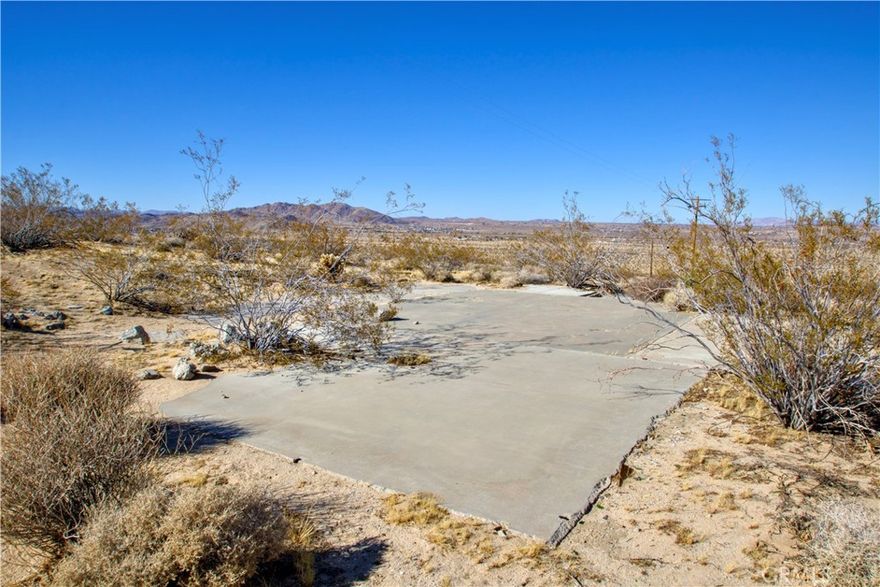 Expansive 5-acre lot backs up to the beautiful Joshua Tree National Forest. Power and Water at the street.  Conveniently located 2 blocks from High Desert Medical center, 3 blocks from Police Department and Highway. Build your own home set in a serene environment, this property offers a unique opportunity for those yearning for peace and a connection to nature. Land has old home pad still on it. Joshua Tree National Park offers a world of outdoor recreation, including hiking, biking, and camping. As one of the few undeveloped parcels near Joshua Tree National Park, this remarkable plot is truly rare! (Google Latitude 34.127174 Longitude -116.279271)  Address is just for posting purposes and not the actual address.
