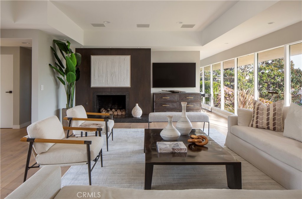 Ensconced within one of the most desirable and exclusive guard-gated communities in Southern California, this recently renovated property boasts a stunning coastal contemporary design. Perfectly situated on the coveted ocean side of PCH, just footsteps away from the community's private beach, this 4 bedroom, 4 ½ bath home offers a luxurious coastal lifestyle in the serene oasis of Irvine Cove. Experience the breathtaking natural beauty of the neighborhood with access to one of the most exclusive sandy coves in Orange County, an oceanfront park, tennis courts, and 24/7 guard-gated security. The mostly single-level home sits on a generously sized plot of nearly a ¼ acre, providing ample space for privacy and relaxation. The backyard is an oasis, complete with an ocean-view gazebo, a sparkling pool perfect for soaking up the sun, and room for entertaining guests. The open kitchen is equipped with top-of-the-line appliances and features a spacious island, making it ideal for hosting. The primary suite is a luxurious retreat, complete with a spa-like bath, two walk-in closets, and a beautiful poolside setting that bathes the room in natural light. Additional secondary bedrooms all feature ensuite bathrooms, ensuring maximum comfort and convenience for all residents and guests. There is also a 3-car garage for convenient parking and storage.