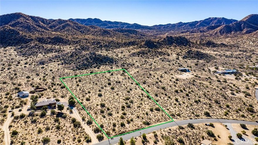 Extremely rare parcel touching Joshua Tree National Park. Walk from your own private property directly onto groomed hiking trails in the Black Rock Canyon area of the National Park. Parcel is nearly 5 acres and includes over 360 feet of National Park frontage. In addition, 250 feet of paved road frontage on desirable Carmelita Circle, which has no through traffic for privacy. Lot is nearly 700 feet deep from paved road frontage to National Park boundary. Utilities (water & electric) required to build a home are already in place at the road. Custom modern house is currently under construction to the west, providing an example of the possibilities. Property has recently been surveyed. No other parcels tucked against the National Park that can be developed are currently for sale in Yucca Valley or Joshua Tree (buyer to check) – this is the only one. Highly unusual location with great views, privacy, wilderness hiking from back of property in an area that will remain forever wild.