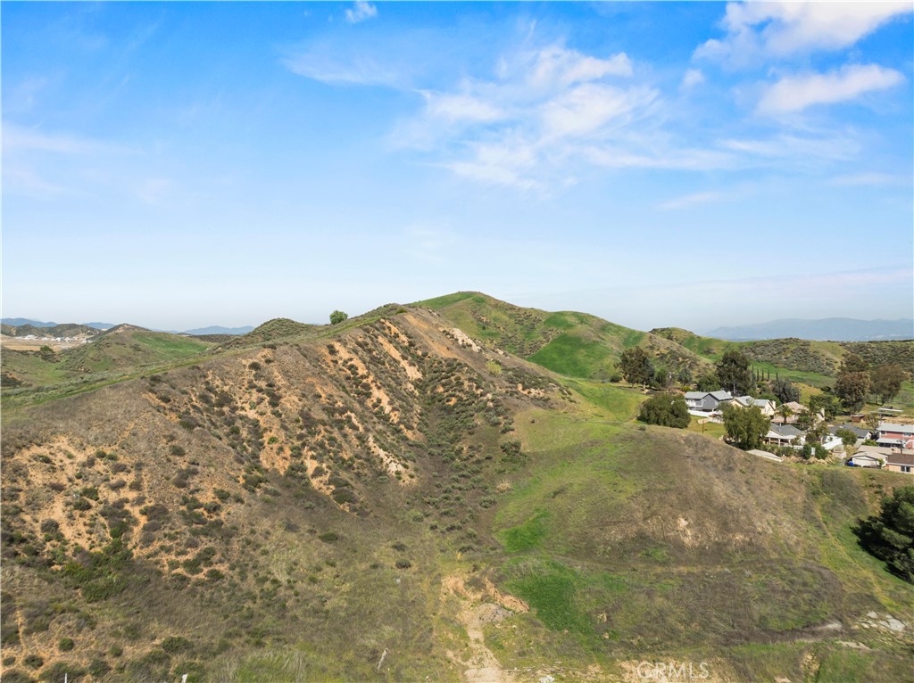 Incredible opportunity to own a residential lot with mountain views in the peaceful Val Verde community. Tucked away at the end of a cul-de-sac atop a private knoll, this property offers privacy, natural beauty, and endless potential. The adjacent parcel is also available, bringing the combined total to approximately 0.85 acres (36,451 sq ft)—ideal for building the home you’ve always imagined. Utilities are nearby. Enjoy the charm of a small-town atmosphere while staying close to the conveniences of Hasley Canyon and Santa Clarita. Minutes from Six Flags Magic Mountain, hiking and horseback trails, the community park and pool, and just a short drive to Castaic and Piru Lakes. A rare blend of rural serenity and accessibility—come see it for yourself! Seller is open to carrying a note.