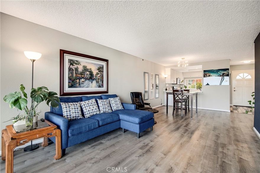 Welcome to this stunning 1-bedroom condo nestled within the peaceful Harbor Gate community, offering a captivating backdrop of lush greenery and sunny skies. From the moment you step inside, a sense of belonging washes over you. The beautifully tiled entrance sets the tone for what lies ahead, leading you into a capacious living area illuminated by an abundance of natural light streaming through a grand wall of windows. This elegant living space, adorned with sophisticated flooring and modern lighting fixtures, effortlessly caters to your desires, whether you're entertaining guests or seeking a place to unwind. Step outside onto your private balcony to bask in the refreshing breeze or cozy up by the gas fireplace on cooler evenings. The kitchen is a masterpiece of both style and functionality, boasting updated cabinets, sleek quartz countertops complete with a breakfast bar, and a suite of stainless steel appliances. The generously-sized bedroom offers mirrored and walk-in closets with thoughtfully incorporated built-ins for your storage needs. The bathroom provides a spa-like retreat, featuring custom-tiled floors, a dual vanity, a walk-in shower equipped with a luxurious rain showerhead, and a deep soaking tub to unwind in. For your convenience, a full-size washer and dryer are thoughtfully included within the unit. Explore the meticulously landscaped grounds, which feature immaculate gardens, mature trees, and tranquil babbling brooks, creating an inviting atmosphere. You're only a stone's throw away from the pool and spa, and parking is effortlessly managed with the inclusion of two side-by-side spaces in the garage. This highly sought-after community boasts a convenient location, placing you in close proximity to grocery stores, exceptional dining establishments, movie theaters, parks, and more.