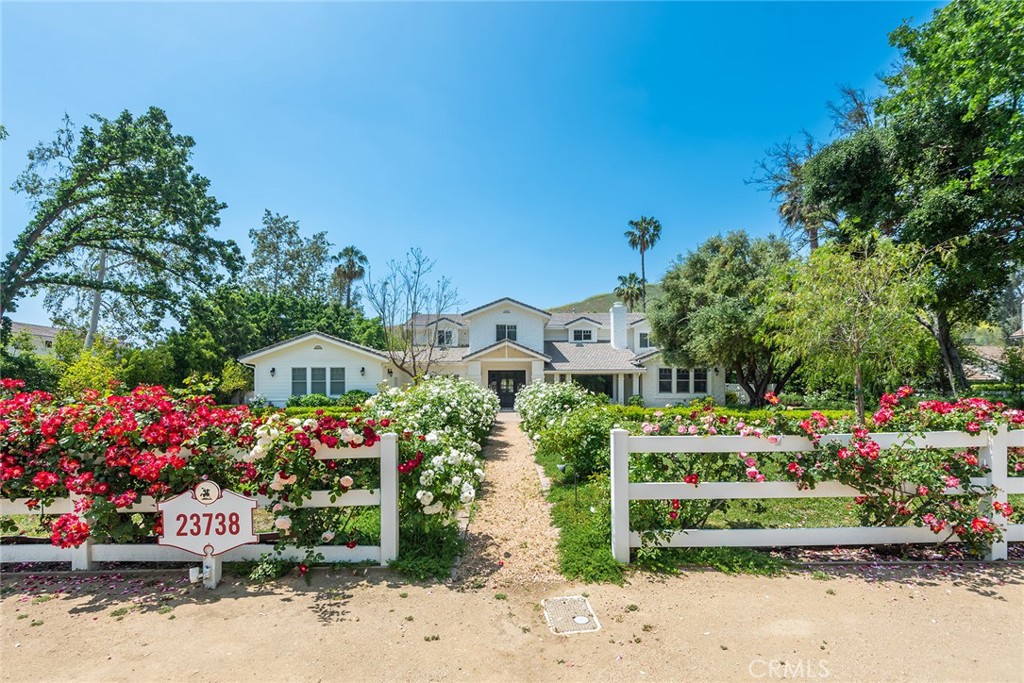 This beautifully upgraded, traditional-style estate spans approximately 9,376 square feet of luxury living and is nestled on over an acre of flat land. Nicely remodeled throughout, highlights include a superb chef's kitchen featuring two large islands, quality, stainless steel appliances, and big, sunny breakfast room. all adjoining the spacious family room with fireplace & French doors that open to a large covered patio. There are also formal living & dining rooms, each with a coffered ceiling and fireplace, a butler's pantry, refrigerated wine cellar, beautiful custom home theater with newer audio-visual equipment, a front facing office, gym & mirrored yoga room, and an additional big upstairs den. There are six bedroom suites, most with newer baths, including a rare, downstairs primary suite with glass encased shower, soaking tub, dual closets and spacious retreat. The truly wonderful grounds are highlighted by a sparkling pool & spa with waterfalls, a fenced and full size sports court (great for basketball or pickleball), pool cabana with bath, plus loads of flat lawn area, mature fruit & shade trees, lush privacy landscaping, and a circular driveway. Don't miss this one!