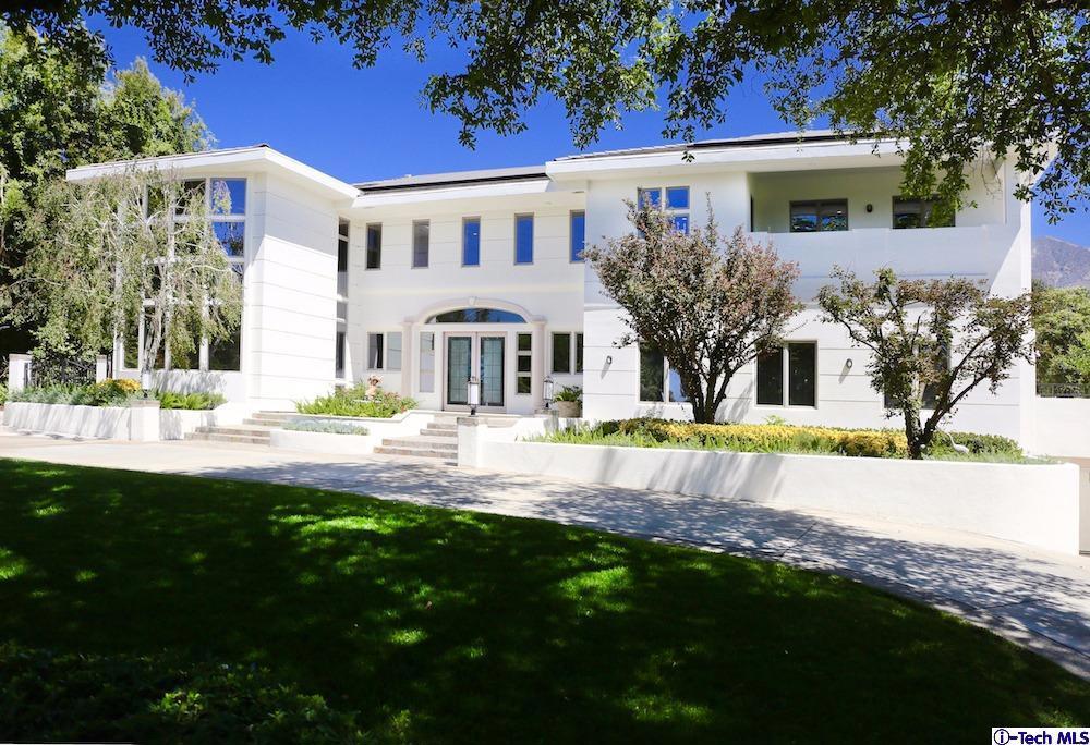 Situated on one of the most sought after streets in the Upper Rancho neighborhood of Arcadia, this estate was completely renovated in 2016. With no detail overlooked, the majestic home is perched on the knoll of a symmetrical lot and faces south, with a circular driveway that leads you to an impressive entry. As you enter the large double doors, you are greeted by the light-drenched grand foyer with double staircases and 35-foot ceilings. The main level of the home features all the amenities needed for resort-style living and entertaining including a dramatic two-story library with amazing windows and full guest suite. Views of the mountains are complemented by the swimming pool/spa, pergola, putting green and lawn. The second level offers four bedroom suites in addition to the master suite with spa-like bathroom, sitting area and balcony. LED lighting and solar panels are just some of the energy-efficient upgrades and the professionally landscaped grounds make this truly a one-of-a kind home. Perhaps one of the most impressive features is the subterranean 7-car garage. Located in the award-winning Arcadia School District, this home offers you a true feeling of luxurious retreat. Please visit the property website for more information.