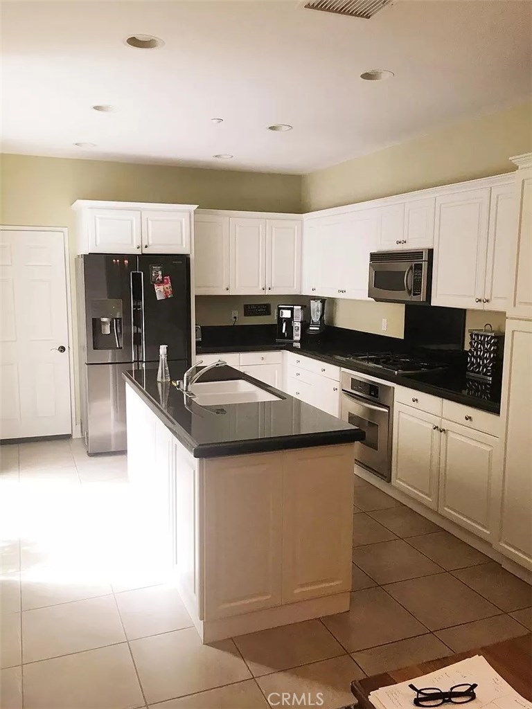 Large, beautifully upgraded, townhome located in the Branches community of Ladera Ranch. A great floor plan that showcases 3 bedrooms, plus a large loft. Upon entry you are greeted with ceramic tile and hardwood floors, designer paint, and crown moulding. The second floor boasts hardwood floors and ample living space. The upstairs loft is perfect for studying, office use, or a relaxing retreat. The master suite, with vaulted ceilings, has ample room for large furnishings and the master bathroom doesn't disappoint with dual sinks. Two additional guest bedrooms upstairs with a jack and Jill bathroom. Thee laundry area is conveniently located upstairs. Stainless steel appliances, center island, recessed lighting, white cabinetry, plenty of storage, built in wall buffet, make your kitchen ideal. Perfect for family or entertaining. Large family room and a large living room, both sharing a cozy fireplace. Tankless water heater and water softener included. Attached 2 car garage for parking and the home is situated on a premium lot. Enjoy all that Ladera Ranch has to offer, including swimming pools, biking, trails, award winning schools, and community events.