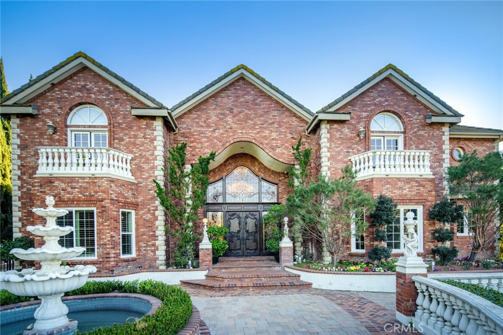 This classic English Tudor estate, renovated in 2013, is nestled in the prestigious 24hrs guard-gated community “The Country”. A large private driveway leads to a spacious 4 cars garage with more parking spaces on the side of driveway. The dramatic 2-story foyer with gleaming marble floors, immaculate wooden staircase and a dazzling chandelier welcomes guests to this 7 bed 8.5 bath custom appointed residence with 2 wood paneled offices and a deluxe private theater with stunning mountain and hill views. The resort-style backyard oasis showcases with pool and spa, outdoor kitchen and lighted tennis court surrounded by beautiful landscaping and palm trees for a tranquil space to entertain. A residential elevator is included for your convenience. The formal living room, dining room, wine cellar, bar, and home theater are ideal for entertaining both large crowds and intimate gatherings. Enjoy the lavish chef caliber kitchen with designer-selected finishes, high-end appliances, custom cabinetry, oversized center island and pantry. The breakfast nook with hand-painted wallpaper surrounded by windows overlooks beautiful backyard. The impressive master suite offers a fireplace, large sitting area, dual custom closets, relaxing Sauna room, and inspired bath. The balcony overlooks the pool, tennis court and lush garden. This traditional estate with incredible attention to detail is also close to H-Mart, parks, all major shopping centers, with easy access to 60 & 57 freeways. This home is also in the award-winning Walnut School District.