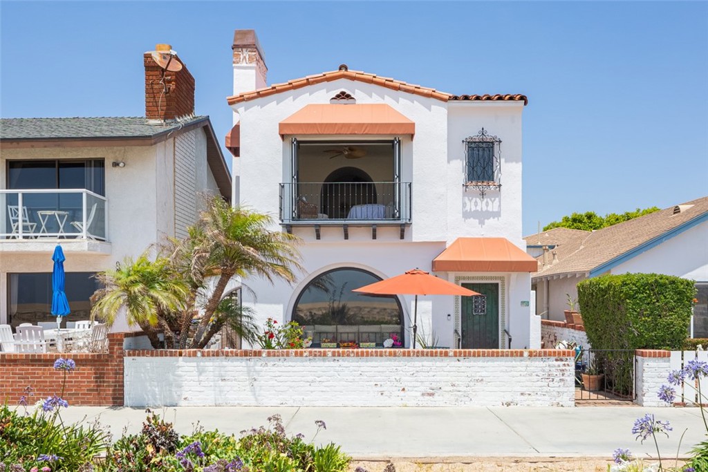 Situated on the coveted oceanfront in Newport Beach on Balboa Peninsula with Catalina views from the second floor, this Spanish style home offers unparalleled access to the vibrant coastal lifestyle. Enjoy this rare opportunity to live at the end of the boardwalk which offers the convenience to the boardwalk without the disturbance of the beachgoers. This beachfront gem has 3 bedrooms and 4 bathrooms with a 2 car garage and is adorned with exquisite details, including arched doorways, hand-painted tiles, and intricate wrought iron accents that epitomize the Spanish aesthetic. This residence has undergone recent upgrades, including the installation of new solar panels, a new roof, fresh exterior and interior paint, new windows, new hardwood floors on the first level and primary bedroom, a new heat pump and AC, an outdoor shower and an EV charger. The spacious living room is a sanctuary of comfort and boasts high ceilings, exposed wooden beams, and a fireplace with breathtaking views out to the dunes and ocean. The charming kitchen features stainless steel appliances, electric stove top and plenty of storage. The serene primary suite is a sanctuary of relaxation, featuring a private balcony, attached sitting room, fireplace and spacious newly remodeled primary bath with views of the ocean. Additional bedrooms provide comfortable accommodations each offering their own unique charm and bathrooms. Step outside and enjoy spectacular sunsets on the patio and spend your days basking in the sun on the sandy beaches or exploring the charming shops and restaurants, the Fun Zone, Balboa Island Ferry, and the world famous Wedge. With convenient access to major highways, you're just a short drive away from the world-class attractions of Orange County and beyond.