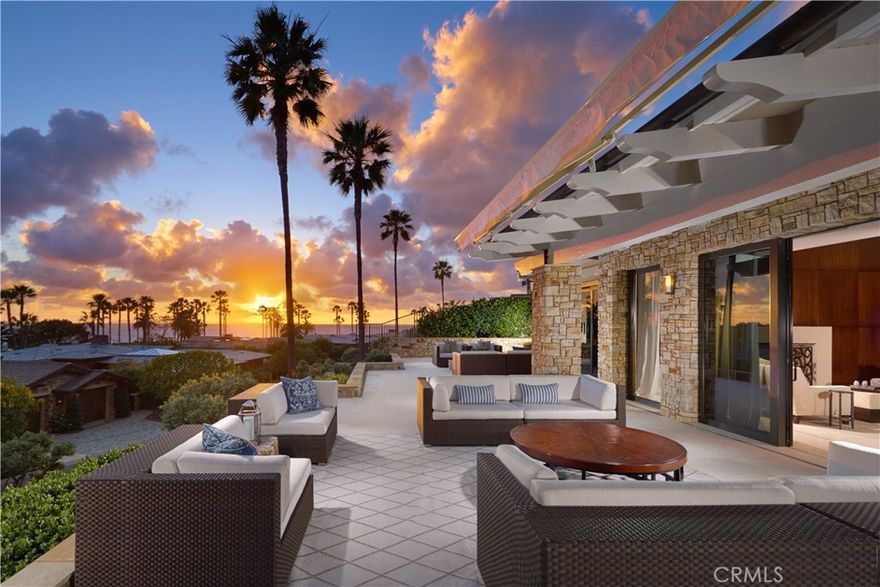 Situated on a private corner parcel at one of the world's most prestigious resorts, this beachside masterpiece affords the homeowner unbridled luxury in its many forms. Vast views of the Pacific abound from the nearly 8,000 SF open-concept residence inspired by Morris Skenderian and Danielian Architects. Slide-away stackable doors and an expansive wrap-around patio prove vital to the indoor-outdoor lifestyle experienced at the estate. An artful gourmet kitchen appeases the eye and the appetite alike with gleaming Mahogany cabinetry, three sinks, built-in espresso machine, and premium appliances; while, a central courtyard with water feature enhances the sense of ease that is felt within the methodically designed home. Three large en suite bedrooms, each with patio access, grace the main level. The utmost in comfort and convenience is found in the ocean-facing master suite fit with private fireplace and spa-bath featuring two distinctive sides, one with handsome dressing area and adjacent office, the other with walk-in closet, vanity area, and indulgent soaking tub. An elevator or staircase descent to the lower level unveils an additional guest en suite, wine cellar, and bonus or media room showcasing dramatic soffit lighting and swanky bar for overflow entertaining. In addition to a premier coastal location, residents of the estate benefit from access to the world-class amenities of the resort including personal concierge services, pool, wellness spa, and private dining.