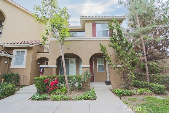 This LIGHT and BRIGHT home, nestled near a beautiful greenbelt is premium END UNIT with ADDITIONAL WINDOWS! Featuring two spacious bedrooms, a private patio, and direct-access two-car garage, this flowing floor plan boasts a sparkling kitchen, custom painted interior, upgraded plush carpet, stately laminate wood flooring and convenient inside laundry room with built in cabinetry! The SPACIOUS MASTER SUITE features large balcony, walk-in closet as well as master bath with dual sinks and luxurious soaking tub. JUST STEPS TO RESORT-STYLE pools, spas, private fitness center, tennis, basketball, volleyball, the upscale shops and restaurants PLUS award winning Irvine schools!