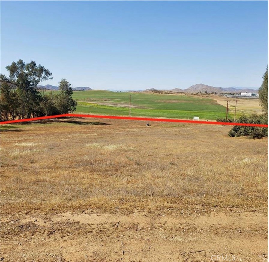 Great opportunity to own approx. 3.2 acres of buildable land in the heart of Menifee. This property is lined with mature eucalyptus trees and has fabulous views of local hills and mountains! The lot comes equipped with a well and power is at the property line. Located just off Scott road, with easy access to the freeway, this is a great location for the commuter or anyone looking to build a custom home on a larger lot. Buyer to perform their own due diligence to verify property lines, access to utilities, zoning, and usage.