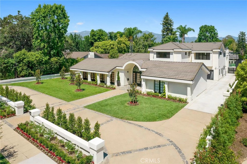 Newly transformed haven nestled in the heart of San Marino! This meticulously renovated modern estate stands as a testament to opulence, with every inch thoughtfully crafted for a lifestyle of grandeur. A symphony of light and luxury unfolds within its walls, the allure of a canvas of marble floors that stretch throughout. This architectural masterpiece, adorned with a unique arched front door, beckons those with an eye for the extraordinary. Step beyond the threshold into a world of glamour, where the foyer unfolds into a large formal living room. Anchored by a fireplace boasting book-matched natural marble from floor to ceiling, this space is graced by multiple French doors that gaze out upon a covered loggia. Pass through hallways flanked by charming, enclosed courtyards, leading to a generously grand family room with ceilings that soar to twelve feet. From this vantage point, gaze out the French doors to the sparkling pool and a full-size lighted and newly resurfaced tennis court in the rear yard. Two private suites flank the family room, one with direct access to the inviting swimming pool, while a third bedroom en-suite bedroom offers a private retreat. The extra-large kitchen is a gourmet chef’s dream. The brand-new luxury kitchen features a super-sized central island, and top of the line appliances, and a large glass-paneled garden window lights up the entire kitchen. The casual dining space adjoining the kitchen showcases a Nero Marquina Marble fireplace. Walk from the kitchen through the sliding glass doors to the adjoining patios to enjoy your morning coffee. Ascend two steps from the family room, and your gaze will be captured by a mesmerizing two-story window wall. Here, natural light cascades, amplifying the beauty and uniqueness of the home. A grand staircase takes center stage, a visual spectacle that harmonizes with the formal dining room, large enough for a banquet-size table. It opens seamlessly to the lush backyard and the beckoning swimming pool adorned with wall fountains. Venture to the second floor, where two suites await, including the pièce de résistance-the primary suite. This sanctuary boasts two generously sized walk-in closets, a beautiful free-standing bathtub, and a shower room with marble-clad walls. This residence is the epitome of California living, an embodiment of a lifestyle rarely replicated. In the enclave of San Marino, this house stands as a singular masterpiece, a testament to unparalleled luxury and elegance.