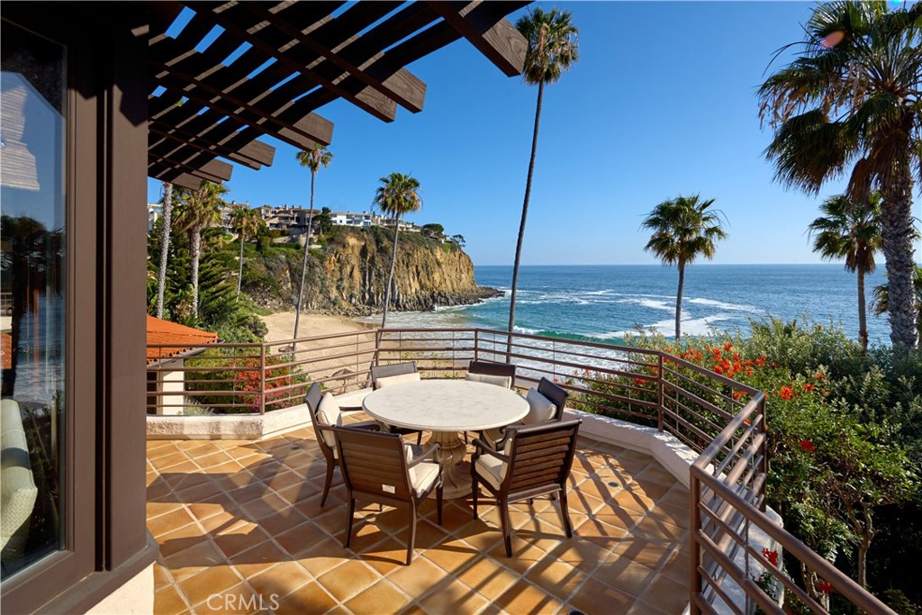 This Irvine Cove oceanfront property is likely one of the most valuable and coveted locations in Orange County and Southern California. Located within the 24-hour guard gated community of Irvine Cove, it is one of only five homes in this exclusive community that have a beachfront location with private access to the sand. Perfectly sited above the beach with spectacular views of the ocean, crashing waves, white water and Catalina Island, this classic Spanish Hacienda style home features approximately 5,500 sq ft of living space, an over 16,000 square foot lot dotted with mature Palm trees and over 123 linear feet of beach frontage. The gracious home features oversized rooms and handsome proportions with vaulted beam ceilings, paver tile floors, hardwoods, a large living room with a fireplace and bar, an informal seating area, a formal dining space, a family room with an entertainment center, an open kitchen with an island, marble tops, stainless steel appliances and an informal dining area. The home features a waterfront master suite with a large bath and walk-in closet, three generous sized bedrooms with en-suite baths and a lower level that can be multi-purposed. Irvine Cove is one of California's most prestigious communities & features a gorgeous quarter mile long private sand beach, 24-hour gated security, a tennis court & park. The possibilities are endless with this property, live in it as-is, enjoy it as a second home, or build the oceanfront property of your dreams.