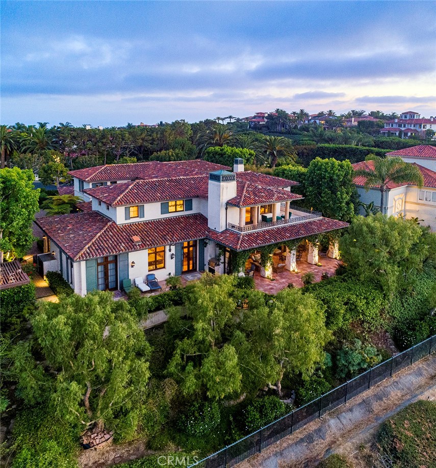 Posted atop the open canyon view boulevard within Newport Coast’s premiere private community, Pelican Hill this estate offers timeless esthetics and a serene setting epitomizing the coastal California lifestyle. From the moment you enter the courtyard gates your greeted by lush mature landscaping, vibrant colors of seasonal blooms and water features providing a tranquil background to this magical environment. Once inside the traditional light filled interiors are reminiscent of Santa Barbara’s historic Montecito district with quality and thoughtfulness around every corner featuring custom construction and fixtures throughout. At just over 7000 sqft on a 19,442 sqft lot the 5 bedroom 5 ½ bathroom residence provides luxurious living quarters for all. Additionally this property hosts wood clad library/ office, formal living and dining rooms, great room that spills into kitchen and breakfast nook, gym, large laundry, grand foyer with wrap around staircase and master retreat with two private bathrooms. The exterior grounds are adorned with perfectly manicured landscaping, covered loggias, outdoor fireplace and meandering pathways that lead you around the perimeter of the home. All of this set within 15 minutes of world class shopping and dining, John Wayne Airport, miles of pristine beaches, parks, the performing arts center and so much more offering little to be desired.