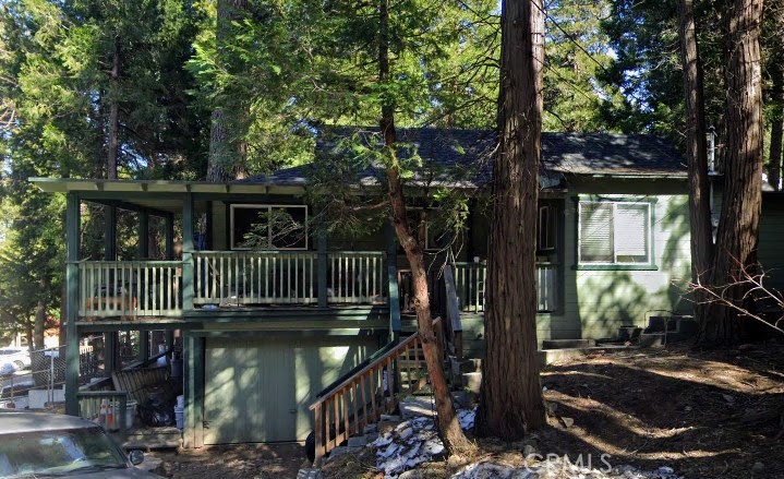 Charming single-level home offering 1 bedroom and 1.5 baths, complete with a single-car garage. The living room is cozy, and there's an adjacent alcove ideal for a reading nook or study. Conveniently, the laundry area is situated off the kitchen, next to the half bath. The backyard is fenced, providing privacy, while a small patio nestled among the trees offers a peaceful outdoor retreat. The front porch, sheltered from the elements, wraps gracefully around the home, adding to its inviting character.