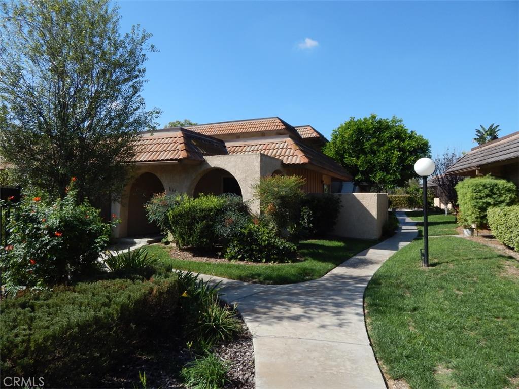 This is a very spacious unit. Conveniently located off of Imperial and Idaho. Very well kept with a small patio. Two very large bedrooms that can fit a king size bed. Inside laundry with a small storage area. This unit is only a few steps from the community pool. The unit includes a one car cover garage and one space. Low cost association that includes water and trash. Complex is very well maintained. This is a must see with many comforts to offer.
