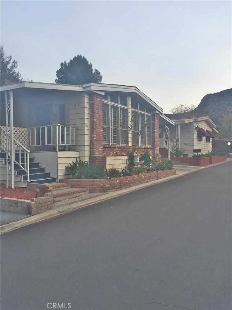 Charming, well kept home in the preferred gated community of Lakehills Estates. This home features newer carpet, plantation shutters on the front room windows, a fireplace, a large utility room and has a nice sized, low maintenance backyard. The price includes the washer, dryer, refrigerator, bar chairs in the kitchen and most of the furniture in the front family room area. Park amenities include a community pool, Jacuzzi, billiard room and clubhouse. Close to Castaic Lake. Minutes from Valencia. Easy access to the five freeway. Financing is available.