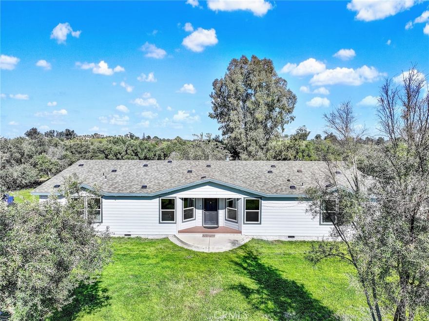 WELL HELLO BEAUTIFUL!! Welcome to 23580 Loleta. Nestled behind an ancient olive grove is this fantastic home boasting 2658 square feet. The well is an impressive 350 feet deep and the solar is PAID FOR, what a bonus on your electric bill. Step up into up into the entry way sand you will be impressed right away. There are two great sized rooms on either side of the formal entryway, each of which would make a great guest suite. The other room could be used as many things, a bar, exercise room, playroom and more. The living room is open concept to the dining area and kitchen. Love to cook? The kitchen is absolutely gorgeous with ample prep, storage and cupboard space. The island is a fantastic size (perfect to put plenty of people around) and the crisp white granite really looks beautiful. Just off the kitchen is the walk-in pantry (storage galore). Each of the bedrooms are a great size and the guest bath also has double sinks (great for 2 people to get ready at the same time). The master bedroom is really nice boasting not just one but 2 walk in closets. The master bathroom is large and has double vanities and soaker tub with nice sized stand-up shower. Most of the home has beautiful wide planked wood laminate flooring throughout with the exception of the bedroom which has carpet. The mudroom is a pleasant surprise with a nice size soaker sink, added storage and a bar to hang your close. This amazing place flows nicely with its vaulted ceilings and natural light that streams throughout. Imagine sitting on your back porch watching the continuing nature that strolls by. Plenty of Dove, Turkey, Quail etc.. The 10 acres of land is level and very usable. Fun fact, there is a huge, covered party area that should surely accommodate a large Croud. There are several outbuildings outside and even an ADU. Some of the best features outside is the brand-new driveway and parking area. This place is absolutely set up for entertaining. If you like to garden there is plenty of outdoor space to do so but there is a greenhouse for any inside gardening, you would like to do. You have got to see it to believe it. Call for an appointment today.