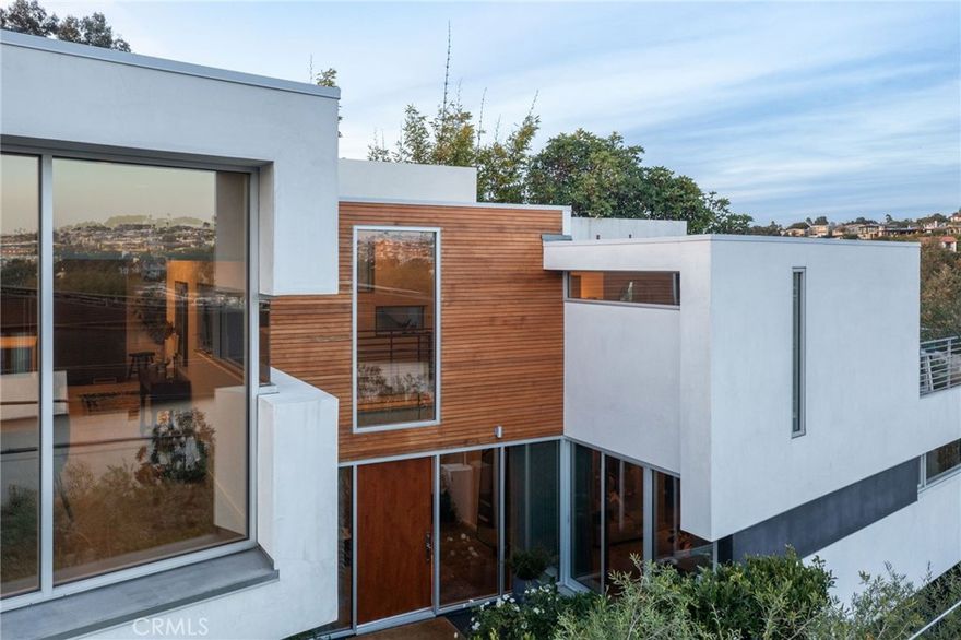 Pat Killen Designed / Built By Kim Komick And Remodeled In The Last 2 Years By Tim Clarke With A Rob Jones Masterpiece Garden. Located between the Piers on an oversized corner lot on top of the Dune w/ panoramic 360 degree views. This spectacular modern masterpiece boasts never-to-be-blocked natural light. 3,700sf of spacious open living space on a rare 4,123sf corner lot w/ city easements & lives like a 6,500sf lot. Fabulous great room/kitchen with ocean, valley, hill & park views from virtually every direction. Gourmet kitchen w/ slab granite counters, custom cabinetry and top of the line brand new appliances. Dramatic floating bridge walkway connects East facing family room and deck with great room. Exceptional master suite w/ en suite sitting area, elegant bath & great park, hill and night light views. Convenient 4 block walk to the beach, Valley Park & Downtown Hermosa and Manhattan Beach. 3 car garage plus RV or boat parking area & a fenced in yard. Large roof top deck w/ all new tile and firepit with exceptional 360 degree views from Malibu, Santa Monica Mountains, American Martyrs Tower, Manhattan & Hermosa Hill Sections, Valley Park, Palos Verdes Peninsula, to Malibu and beyond. If you are looking for a well located, exceptionally designed & built home w/ irreplaceable features, look no further. Located in the heart of a classic coastal neighborhood, this beach house is a nucleus for family and friends. This peaceful retreat unfolds to reveal a thoughtful balance between indoor and outdoor living with many unexpected features. Relaxed but refined, crisp but inviting, the casual elegance of this purposeful environment embraces an active beach life where sun, sand, ocean views / breezes, and memories are closely interwoven.