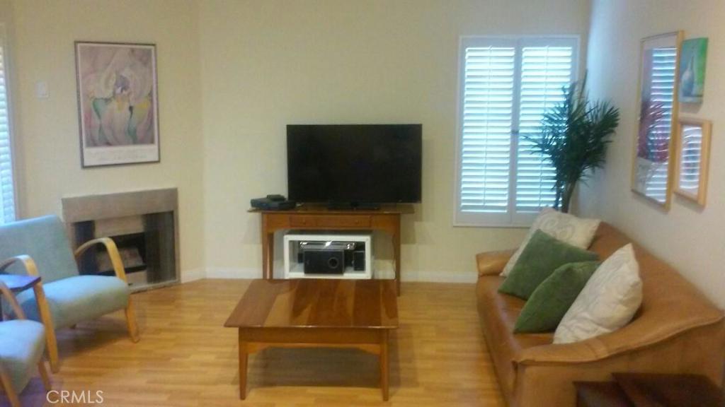 Beautiful refurbished end unit. Light and bright top floor condo. Vaulted ceilings, open kitchen has new painted cabinets, and tiled counters. Spacious living room with corner fireplace. Recessed lighting. Newly painted throughout. New laminate wood floors throughout. Laundry area holds a full size washer and gas dryer. Huge master suite with new bathroom double sink cabinet, counter tops, faucets and tub/shower. Balcony is located off of the living room. Central air conditioning. One car garage is just below the unit. Great location in this gated community just steps from the community pool.