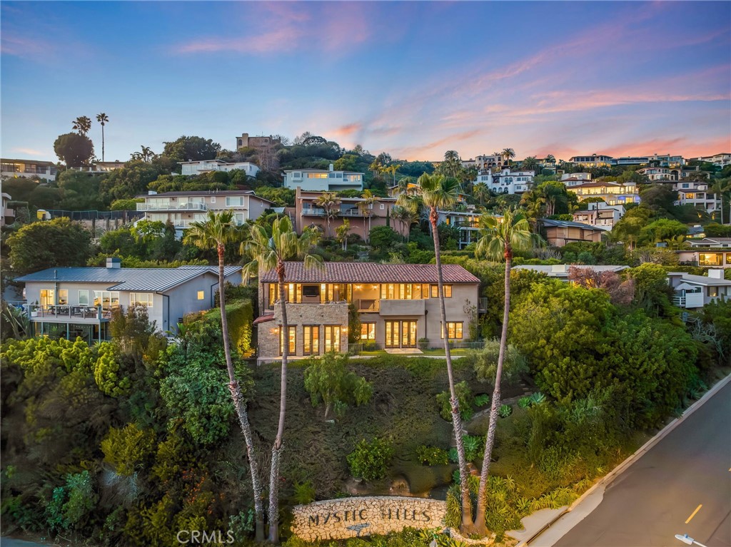 Among the many beautiful homes that dot the hillsides in Laguna Beach, there are a handful of architectural designers whose body of work stands above. 715 Mystic Way is one of the last magnificent ocean view homes completed by John O'Neill. Designed for personal friends, the home displays attention to detail, unexpected ocean view perspectives, and instantly comfortable. The location strikes the perfect balance to provide gorgeous views without being too far from beaches and town. Inspired by vintage Italian farmhouse designs culled from O'Neill's extensive travels, the home highlights authentic design details while perfectly framing the view in a light and open design. The open main level is anchored by a bank of french doors opening to a ocean view terrace and the coastal views beyond. The kitchen, open to the main level great room, is a masterpiece - imminently functional and filled with enchanting details...this is room for gathering, cooking, and conversation. A main floor bedroom, powder and office round out the upper level. Below lies an exceptional master suite, two secondary bedrooms with en-suite baths, and a media area that walks out to the yard. Taken in as a whole, the home is magnificent. But the beauty is in the detailed finishes and thoughtful design. Broad ocean vistas, enchanting architecture, and an enduring architectural statement by a standout designer - 715 Mystic Way stands alone as a rare opportunity to own the best of this unique seaside community.