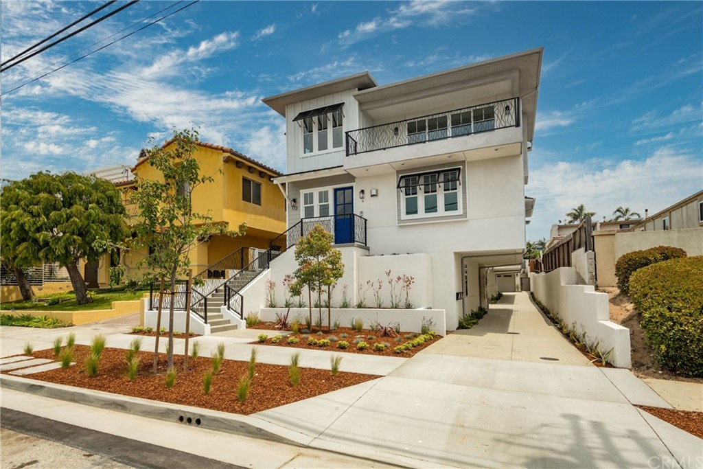 Situated on a quiet street in South Redondo Beach, this wonderful townhome celebrates the California lifestyle. Exquisitely designed and constructed by E&S Prime Builders, this is contemporary living at its best. The charming Coastal Modern exterior only hints at what’s inside. The open concept living space provides an ocean view and is accented by high ceilings, an attractive fireplace and wide-plank hardwood floors. This is the perfect place to kickback after a stressful day. Just outside is a spacious deck that provides a sunny spot to relax or grill something for dinner. The kitchen has generous cabinetry, a large center island, built-in refrigerator, and a 5-burner Italian range. A romantic master suite with a fully outfitted closet and cozy fireplace is an inviting place to end the day. The master bath boasts a free-standing tub, oversized shower, and double sinks with gorgeous fixtures. Three additional bedrooms and two more baths provide plenty of space for guests or working from home. Ample space is the ultimate luxury. An in-unit elevator serves all interior floors. The private roof deck is a great place to get away from the bustle of daily life and enjoy ocean views, sunsets and stargazing. Grab your bike for a ride along the beach, it's two blocks away! Fine or casual dining is walkable. Shopping and award-winning schools are close by. This is life as it should be. Move this townhome to the top of your viewing list.