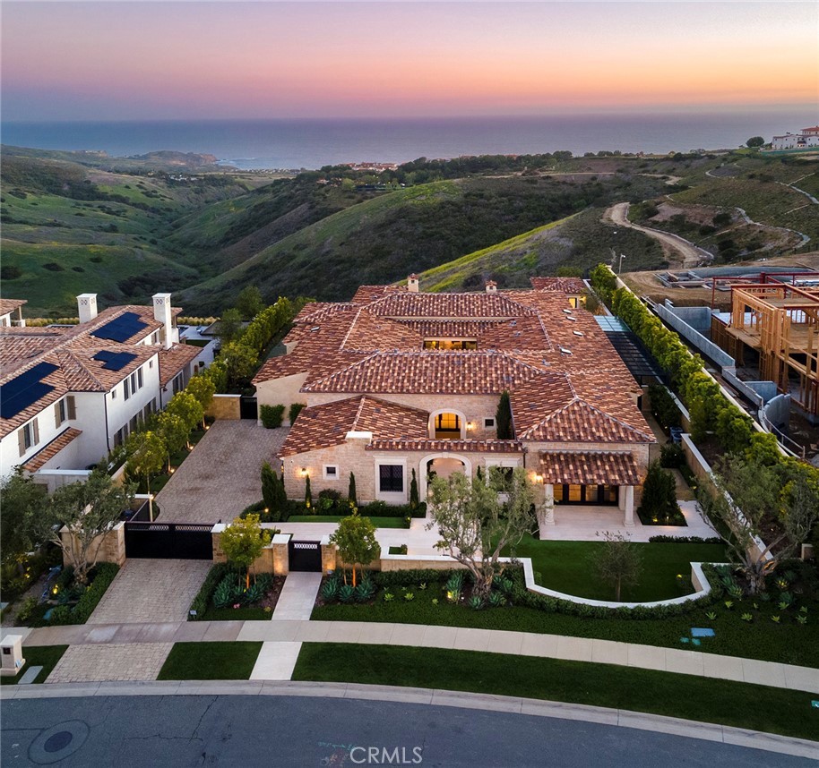 Enjoy the epitome of true single-level living in this equally casual & sophisticated coastal-contemporary custom estate located in the private enclave of Crystal Cove. Perched on a front-row parcel of nearly one half acre, the property enjoys panoramic coastline views, down through the canyon and out to El Moro Cove, with waves crashing on Abalone Point. The smart-home's interior layout consists of three bedroom suites, including one that can serve as a separate casita, if desired, and includes a kitchenette and large living room. The primary bedroom suite looks to the ocean and offers 2 well appointed baths & closets. At the heart of the house lies a gourmet kitchen with soaring beamed ceilings, high-end appliances, custom cabinetry, and an open concept that flows into the morning room & great room and then out into the screened loggia, past a wall of glass pocket doors that disappears from sight, for the ultimate in indoor/outdoor living. Additionally, there is a butler's kitchen / service bar adjacent to the generous formal dining room and in close proximity to the tranquil central courtyard that can be opened to the home's interior on three sides. An ocean view office, 2nd powder room, home gym and well thought-out laundry room round out the flexible floor plan that can be converted to 4-5 bedrooms without the need to add additional square footage. On the exterior, this bespoke residence offers beautifully landscaped grounds, a sparkling pool and spa with cabana and bath, a highly secured dog run, and a gated motor court. The guard-gated community of Crystal Cove has much to offer its residents and guests, including the 2.5 acre Canyon Club for swimming, tennis, work-outs, entertaining and meetings. There are also parks, greenbelts and access to hiking and biking trails. Conveniently located just outside of the community gates, the Crystal Cove Promenade includes many casual and upscale options for dining and shopping. Crystal Cove State Beach sits just across Pacific Coast Hwy.