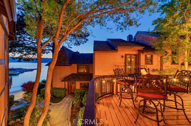 Welcome to the Lake! Desirable Edgewater Shores community featuring a private beach, walking distance to the village, unparalleled views & lake access. Premier updated end unit townhouse, lake adjacent with amazing lake views. Enjoy your summer nights watching the sunset over the lake listening to live concerts in the village from your oversized wrap around deck. This townhouse features 3 bed rms + loft, 2.5 baths, slate fireplace, 3 outdoor patios, renovated kitchen with granite countertops, stainless steel appliances & wine cooler. Dock included with hydro hoist, only steps away! Truly one of a kind, closest proximity to the lake without paying lakefront prices. Don't miss out on this incredible opportunity!