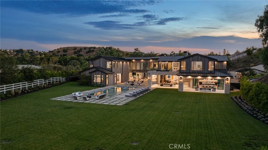 This spectacular, brand new, one-of-a-kind estate offers sweeping views, is nestled at the very end of a quiet private drive, and is sited on a private and beautiful 2.78 acre lot. Bathed in natural light, and featuring over 20,000 square feet of quality, elegance, & sophistication, highlights of the sunny open floor plan include volume ceilings & huge picture windows, sliding walls of glass that open to the spacious grounds, a gorgeous chef's kitchen with two center islands, counter seating, & full catering kitchen, a large adjoining family room, open living & dining rooms that are perfect for casual entertaining, plus a lounge with glass encased, refrigerated wine room, an expansive and stunning home theater with upholstered walls, a custom office with it's own bath, a gym with steam, sauna, and massage room, plus a bonus room, a second (upstairs) den, and a game room with a two lane bowling alley! There are seven large bedroom suites including the magnificent primary suite with sitting room, two sided fireplace, luxurious stone bath, two huge, room sized closets, and a superb lounging balcony overlooking the lush grounds. The enormous backyard offers a sparkling pool & spa, a full barbecue center, two covered patios, and expansive grass lawns with lots of room to roam. Additional amenities include an elevator, two staircases and garages for seven cars, plus loads of off street parking. This home exemplifies the essence of the relaxed, indoor/outdoor California lifestyle. (See property video linked below).