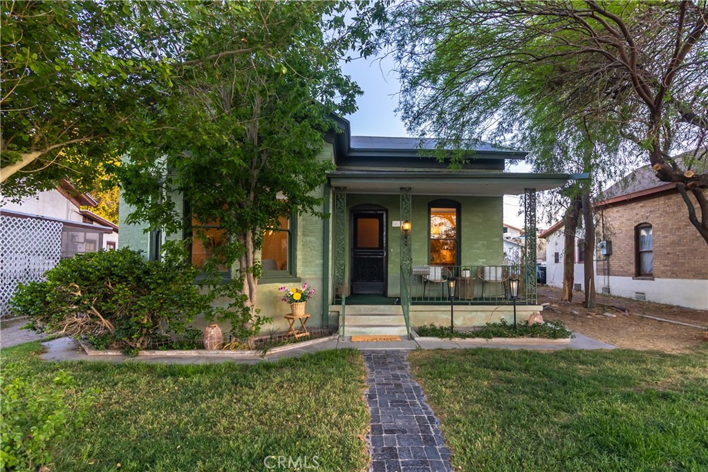 Step into timeless charm with this beautifully preserved historic railroad home, built in 1910 and located just minutes from iconic Route 66. This classic brick beauty features a cozy front porch perfect for morning coffee, and a one-of-a-kind original turn-key doorbell that welcomes you with vintage flair.
Inside, you’ll find 4 bedrooms and 3 bathrooms, with original details throughout that reflect the home’s rich history—including one bedroom with wallpaper that's been lovingly in place for over 50 years. The formal dining area flows into the kitchen, and is also open to spacious living room. This space invites gatherings and quiet evenings alike.
A light-filled family room in the back boasts a full wall of windows, offering peaceful views of the lush, serene backyard. Step outside to the wraparound back porch with graceful arched openings and enjoy the shaded courtyard surrounded by mature trees, perfect for relaxing or entertaining.
Very well maintained and thoughtfully refreshed, this home blends just the right amount of modern comfort with the soul and character of its historic roots. Don’t miss your chance to own a piece of living history!