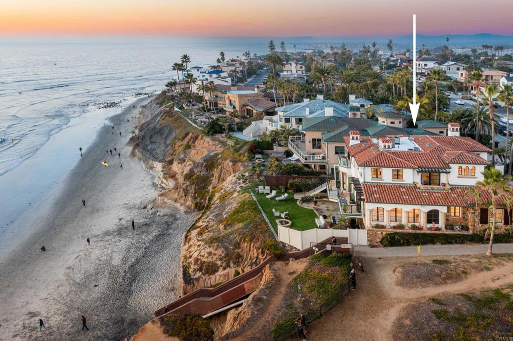 Reduced again.. 10/03/2023... BEYOND a Screaming Deal! Oceanfront Estate PLUS GUEST APARTMENT with newness, style, luxury & PERFECTION priced $2.25m UNDER the recent appraisal & the LEAST expensive property per square foot on the oceanfront from La Jolla to Carlsbad (at time of reduction). Straight out of Hollywood & perfectly configured for multi-generational living, the home features 5+Bedrooms (plus office, media & wine room)-a total of 5950sf including a 1000esf sumptuous ocean view Guest/Caretakers Apartment (separately alarmed with private access). This property has it ALL with luxury, newness, direct beach access (year-round), loads of parking & a .5 acre site protected by 73’ of sea-walled frontage and NO sand mitigation fee! The new owner will enjoy all the joys of a beachfront home without the hassle of remodeling/rebuilding. The envy of all and the epitome of what people picture when they think of Southern California living with basically two residences in a singular structure. Guests, staff, or caretakers can enjoy the spacious 1000esf lower-level ocean-view apartment offering a spacious bedroom suite, family room, second ¾ bath and wet bar. And the main residence provides for 4-bedrooms plus office, media and wine room complete with a luxurious elevator (accessible to all 3 levels) which provides for the equivalent of single-story living. Killer parking with 3-car garage plus 4 additional off-street parking spaces. Easy access to Palomar Airport (10min per Google) for jetsetters looking for a quick getaway. Rare to find “like-new”/already renovated on the oceanfront - the owner has gone through the home with a fine-tooth comb, upgrading/replacing and updating everything needed from mechanical & practical to window coverings, flooring, lighting, smart home system/Audio Visual components and more! Anything and everything that needed to be replaced or maintained has been done. Oceanfront living is fabulous anywhere BUT the breadth of view here is spectacular as it is sited next to state park land to the South, so your view extends for miles - one that few to no other properties in San Diego County enjoy. Open and airy with wonderful flow and numerous balconies that capture glorious whitewater views and incredible sunsets from virtually every room in the house, living here is like winning the lottery every day of your life! Better yet, the option is extended to purchase all of the luxurious furnishings/turnkey. At the listed price this is an incredible value under market - Seller says SELL!