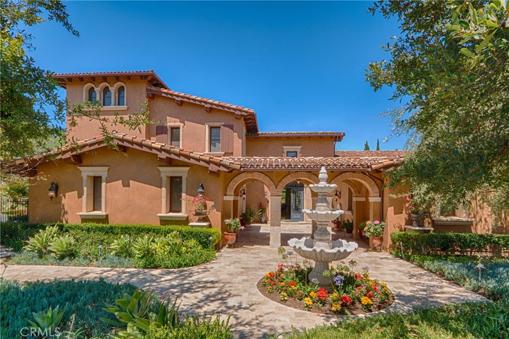 An unobstructed canyon panorama and the serenity offered in Shady Canyon await you at this Tuscan-inspired masterpiece. Enter thru custom wrought iron doors to the grand foyer with soaring ceilings with glistening chandelier and custom inlay marble floor. The main level of this estate boasts formal living and dining rooms, arched ceilings, wood carved crown moldings, custom lighting and imported hardwood and marble flooring throughout. Immediately adjacent are the chef's kitchen with top of the line appliances, custom cabinets, butler's pantry and adjoining den. On the north wing of the estate are two en suite bedrooms and game room with wet bar. The south wing has an additional en suite bedroom, spacious bonus room/office, laundry room and marble staircase leading to the upper level. The second floor features a grand master suite, large bath with steam shower and a balcony to view magnificent city lights and canyon views with peek-a-boo ocean view. A separate owner's quarters and additional en suite bedroom complete this level. The tower loft offers spectacular views for an artist loft or personal retreat. The outdoor entertainment area with granite/kitchen island and built-in bbq. The grounds are complemented with salt-water pool, spa and fruit trees and mini-vineyard.