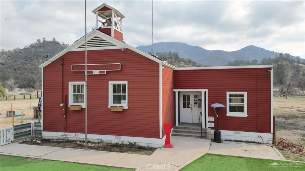 Calling all investors and restaurateurs alike for a once in a lifetime opportunity to own the historic Schoolhouse Grill located in the heart of the beautiful community of Twin Oaks in Caliente, CA.
Situated on 3.14 acres of flat and completely usable land, the mixed zoning parcel includes a historic restaurant, 2 occupied residential units, and space developed for dry camping/RV parking sites. Generating multiple streams of income, there's plenty of room for a new owner to continue and expand its current use.
Originally built in 1934 as a schoolhouse, this restaurant has been thoughtfully transformed into a beloved dining destination, seamlessly blending historic charm with modern amenities. The main building retains its original wood floors and chalkboards, offering an authentic glimpse into its storied past. Everything you need to continue this successful and bustling business is already in place. All equipment, appliances, tools, utensils, dishes, cookware, furniture, and most of the decor is included with this amazing opportunity. The kitchen and bathrooms were entirely remodeled and expanded in 2021. A lovely patio provides ample outdoor seating, ideal for hosting events and live music. The restaurant serves as a community hub with several annual events drawing residents and tourists alike throughout the year.
The combination of historic ambiance, a loyal customer base, and a prime location make this a standout property in the Caliente area. Don't miss the chance to own a piece of history and continue the legacy of the Schoolhouse Grill.