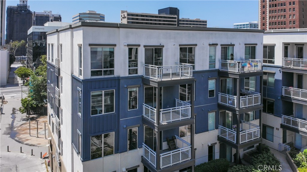 Welcome home to your downtown luxury condo with a prime location by Alamitos Beach, Queen Mary, Pike Outlets, Aquarium of Pacific and Shore Line Village, shops, and restaurants! Only one block from the Ocean Boulevard. 150 The Promenade is an upscale building with controlled access and gated garage. This lovely end unit is located on the top floor and features city and courtyard views. The entry level features a gourmet kitchen with stainless steel appliances, granite counters and island bar with seating. The spacious living room with its private balcony provides ample natural light and fresh ocean air. The top level also features a dining area and bedroom with full bath. Down below is the owner’s bedroom with balcony, bonus nook and well-appointed bath, another bedroom and bath, and inside laundry. Additional home features include new carpet and interior paint, included refrigerator, washer and dryer, recessed lighting, and dual zoned air conditioning. The community offers many amenities including a large community room, Amazon package lockers in the lobby, plus an outside patio with firepit and BBQ area.