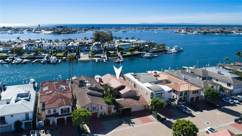 An unparalleled haven for yacht enthusiasts, this bayfront residence on Linda Isle is meticulously designed to embrace the epitome of stylish indoor-outdoor living. Boasting a generously sized waterfront deck, a private boat dock, and breathtaking views culminating in spectacular sunset panoramas, this home occupies the premier location for convenient docking and enjoyment on what most regard as the best orientation Linda Isle has to offer. The main level unfolds with a secure gated courtyard and an elegant entry, leading to a capacious waterfront great room adorned with a formal living and dining areas and well-sized fireplace. The ground floor also offers an adjacent kitchen with ample storage and counter space, a separate informal eating area, spacious laundry room as well as a family room/media area which could be used as a fourth bedroom. The second level affords an oversized primary suite that spans the width of the home offering incredible main turning basin and sunset views with separate seating area and fireplace. The primary suite is well complimented by a large walk-in closet, a spa-like bathroom with separate vanities, walk-in shower and jetted tub. Two secondary bedrooms sharing a spacious bathroom complete the second level. The private dock, capable of accommodating a boat of approximately 65', further enhances the property's allure. Linda Isle stands as Newport Harbor's exclusive 24-hour gated and secured island, providing effortless access to freeways, John Wayne Airport, and the upscale amenities of Fashion Island. With 107 waterfront residences, a tennis court, a clubhouse, and a children's play beach, Linda Isle offers a lifestyle of luxury and leisure. Beyond the confines of this exquisite residence, all the pleasures of Newport Harbor await—whether it's swimming, sailing, paddleboarding, kayaking, bike riding, or cruising in a Duffy electric boat to savor the waterfront's restaurants, clubs, and nightlife. This residence encapsulates the essence of coastal living at its finest.