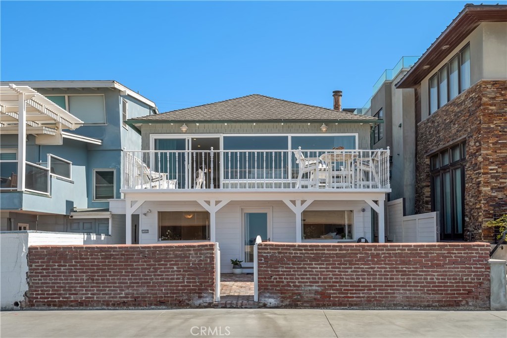 Situated on a gorgeous stretch of The Strand in North Hermosa Beach, this grey-shingled, updated duplex features two units in 2502 square footage on the sand. Ocean views don’t get better than this, and with the Pacific providing the perfect background to your every view, this property, with its red brick patio and coastal interior, is an exclusive opportunity for those seeking the best location possible. The front unit features three bedrooms and two baths, with a whitewashed living room and wide deck overlooking the beach, a tucked-away family room, full dining area, and darling kitchen with cozy breakfast nook. Amenities such as an inviting fireplace, custom built-ins and bleached oak floors envelop the space in warmth and cheer. The primary bedroom and bath and a second bedroom are at sand level, with a generous patio just steps outside the doors. The bathroom is bathed in sunlight and includes a lavish soaking tub for warming up after a dip in the ocean. The third bedroom and office space on the second floor are charming and convenient to hosting and working from home, and the barbecue patio hosts a built-in cooking station. The second unit is a perfect in-law or guest house, including a spacious family room with cathedral ceiling and original brick fireplace, full kitchen with stainless appliances, ¾ bath and brightly lit bedroom. With two separate living spaces and a location second-to-none on the Strand in Hermosa Beach, this property is an absolute gem.