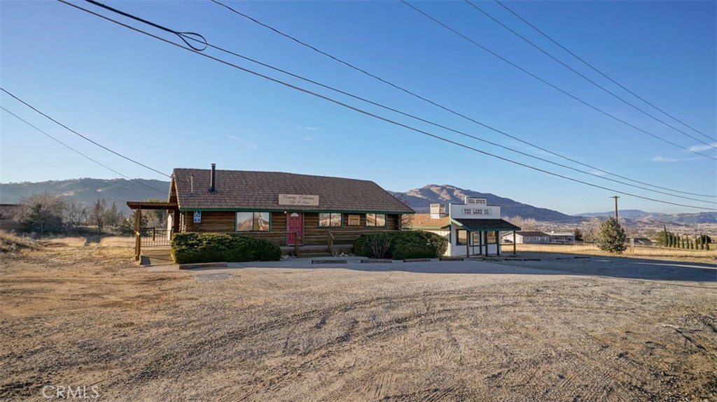 2 buildings on one property. One is a cute log cabin that people love to visit. The other is a small office that looks like a train station. The train loop was the origination of Tehachapi. The log cabin has 3 bedrooms and 2 baths which can be easily converted into drs office, other office, or beauty stations. There is also an area that can be converted into a kitchen. Log cabin has a side and front deck. The small office has 2 office rooms with a bathroom and a kitchen space with frigerator. There is a lot more room on the property for other structures. Located in Old Town and close to city conveniences such as market etc.