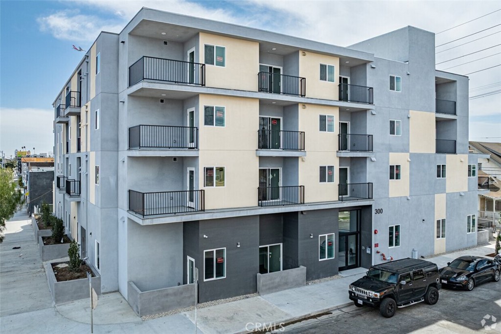 Located in the heart of South Los Angeles, this four-story residential community at 300 W. 60th Street provides a blend of modern design and practical living. Constructed in 2025, the property spans 38,862 square feet and consists of 60 well-designed one-bedroom apartments, ranging from 360 to 569 square feet. Nearly two-thirds of the units feature private patios or balconies, offering residents additional outdoor space.
Upon entering the secure building, residents are welcomed by a thoughtfully designed lobby and common areas that enhance the living experience. The ground floor includes a 1,084-square-foot recreation room that can serve as a communal space or be converted into an office for supportive services. Additionally, the building provides convenient amenities such as a designated bicycle storage room with 48 spaces, an Amazon Hub package retrieval system, and a centralized mailbox area. Three laundry rooms are located on the second, third, and fourth floors for added convenience.
Located in a well-connected area, this property offers excellent access to public transportation, with Metro bus stops along Broadway, including one just steps from the entrance at Broadway & W. 61st Street. Its strategic placement provides residents with an easy commute to employment centers in South Los Angeles, Huntington Park, Vernon, and Downtown Los Angeles. Families will appreciate the proximity to local schools, including 61st Street Elementary, Juanita Tate Elementary, and St. Columbkille School.
Residents also benefit from nearby shopping, dining, and essential services, creating a walkable and convenient neighborhood. Additionally, the property is just one block east of the 110 Freeway, with easy access from W. Gage Avenue or Slauson Avenue, ensuring seamless connectivity throughout the city.
This newly developed property offers a well-balanced combination of affordability, modern amenities, and convenience, providing much-needed affordable housing in an accessible location for residents seeking stability and community support.