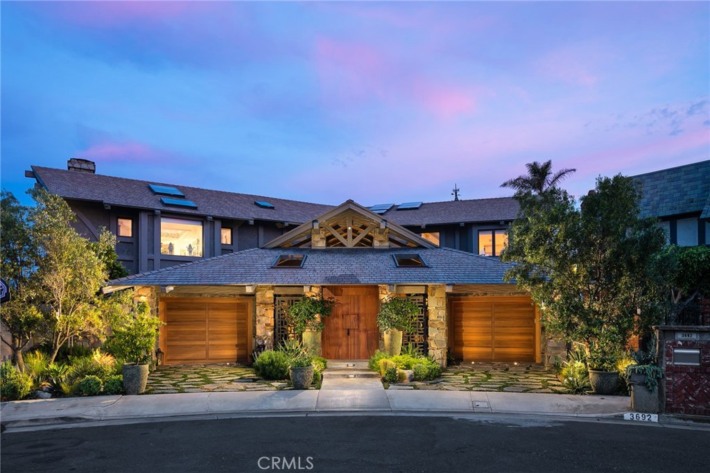 A vision of timeless architecture – presented in an exceptional waterfront estate. This true legacy property created by notable custom home builder Ken Bourguignon, embodies design and construction transcending time and trends. Enveloped by tri-channel views, the striking structure is a collection of rare materials and precision-crafted finishes that delight the senses. Every space of this remarkable home is a statement of refined design with an assemblage of rarely executed attributes including artfully laid stone wall cladding of Bouquet Canyon; impressive hand-hewn beams; intricately carved, imported Italian wood ceiling details; poured and polished concrete, and an abundance of exotic hardwoods and stones; a ‘floating’ stair with glass surround; elevator accessibility; and a meandering atrium-to-interior Koi pond. The nearly 8,000 square-foot parcel is an accommodating environment with myriad gracious interior living areas replete with luxury amenities, as well as an expansive waterfront terrace crowned by a 186’ private dock to accommodate a large vessel or multiple smaller craft. This never-to-be-replicated residence affords an extraordinary opportunity for stylish, sophisticated living – in one of the region’s most desirable waterfront locations.